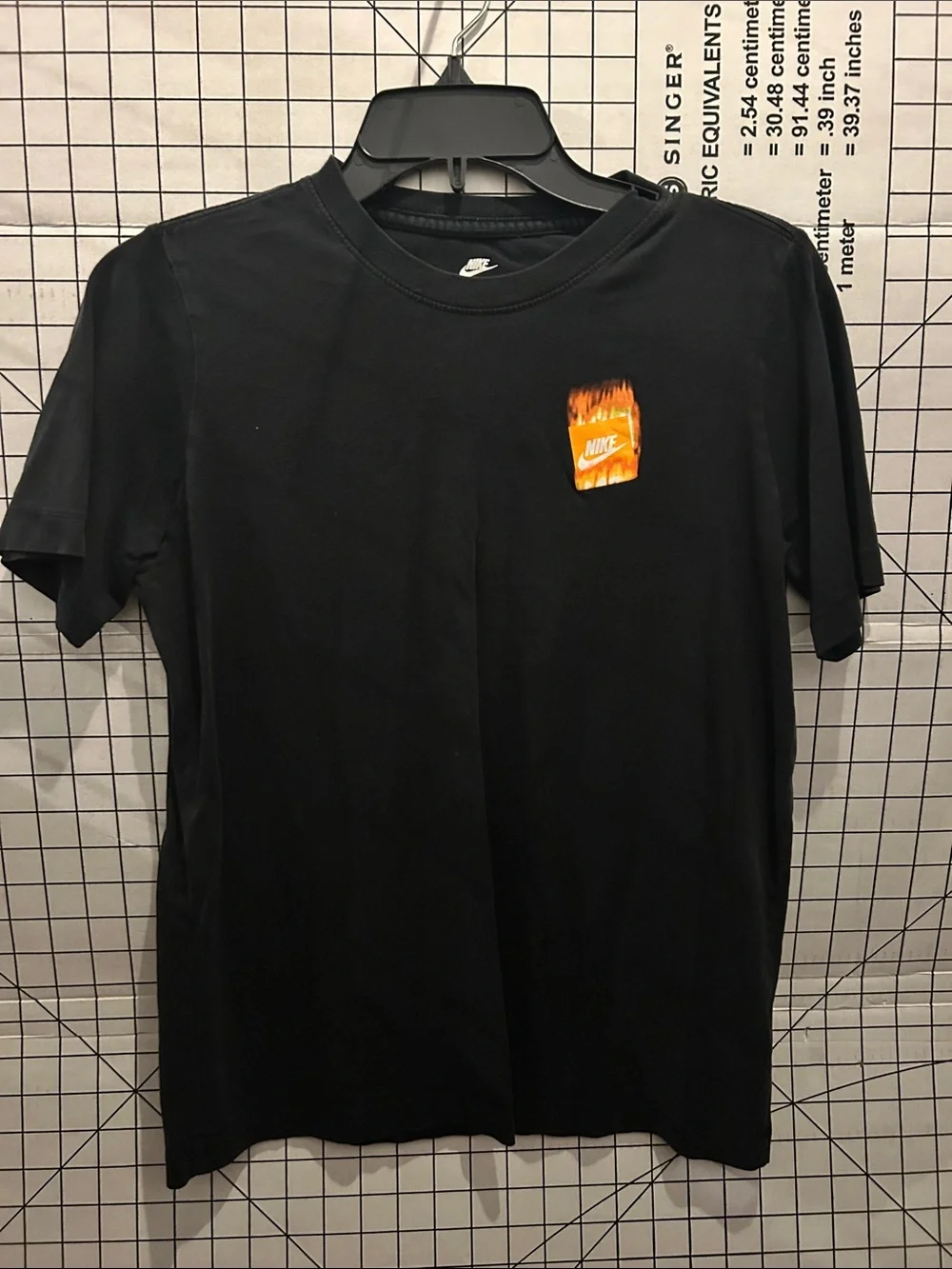 Kid’s Nike Black Short-Sleeve Tee with Orange Flame Chest Graphic